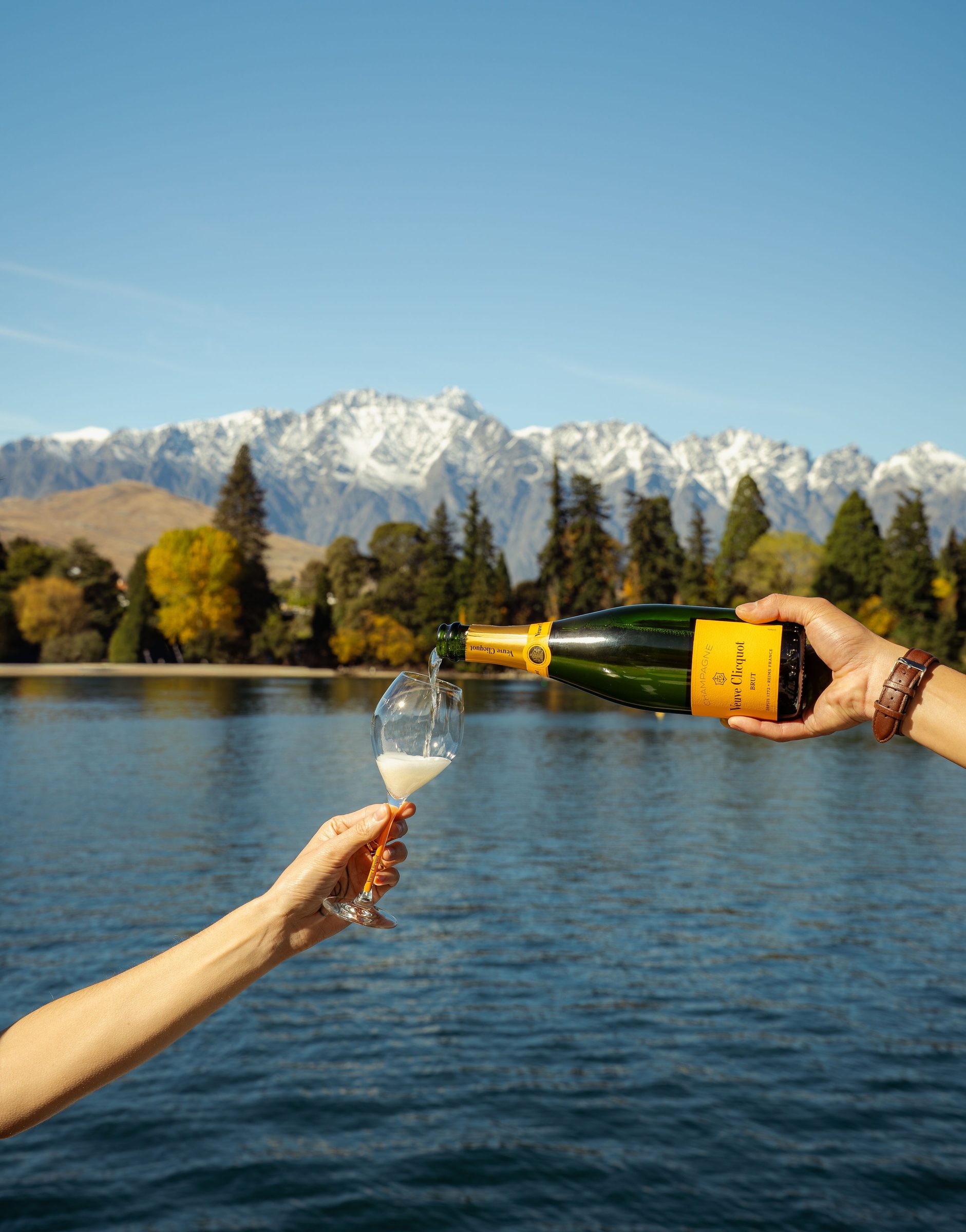 Champagne pour with the Remarkables in the background, Pacific Jemm