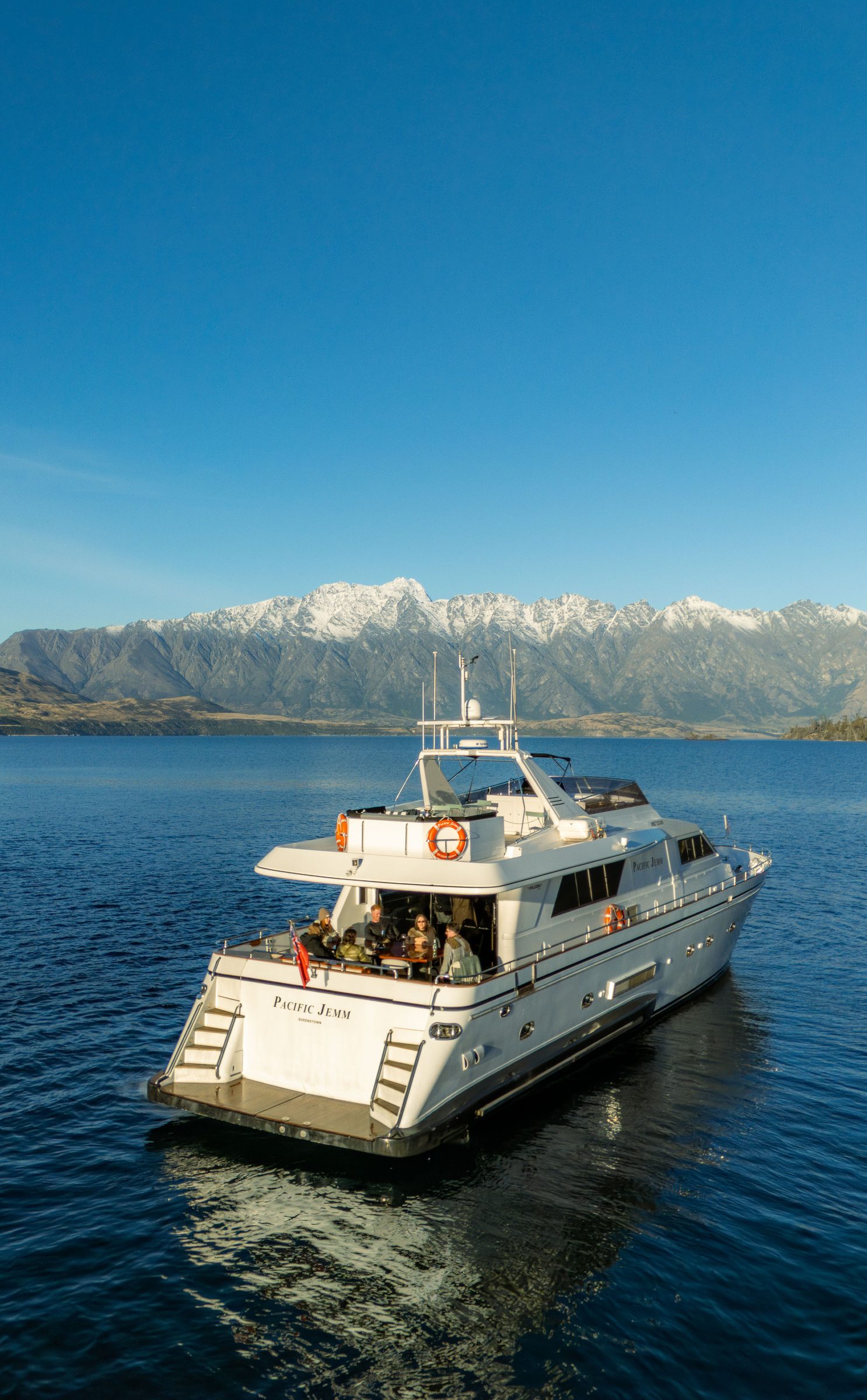 Pacific Jemm cruising Lake Wakatipu beneath the snow-capped Remarkables