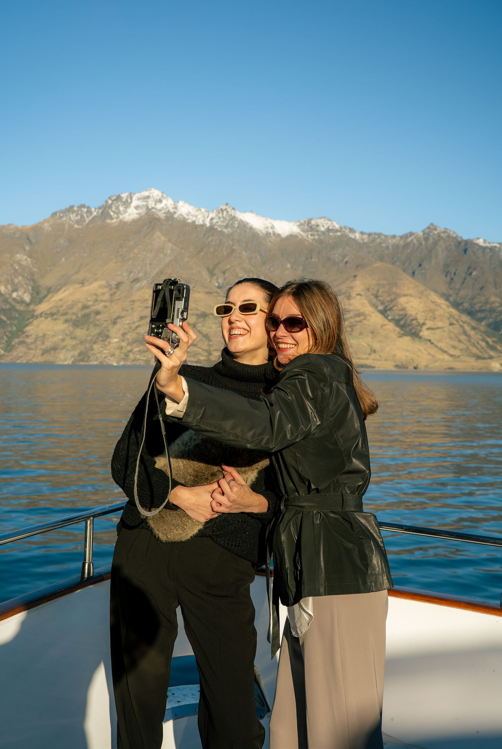 Guests aboard Pacific Jemm with The Remarkables behind